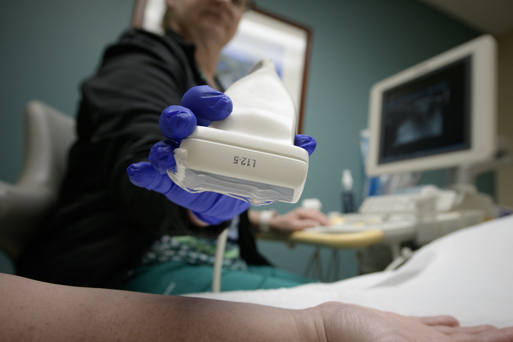 Ultrasound probe held over a patient's arm