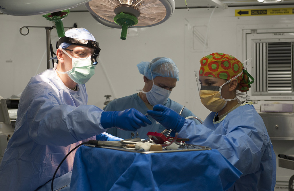 Surgeons operating in an operation theatre